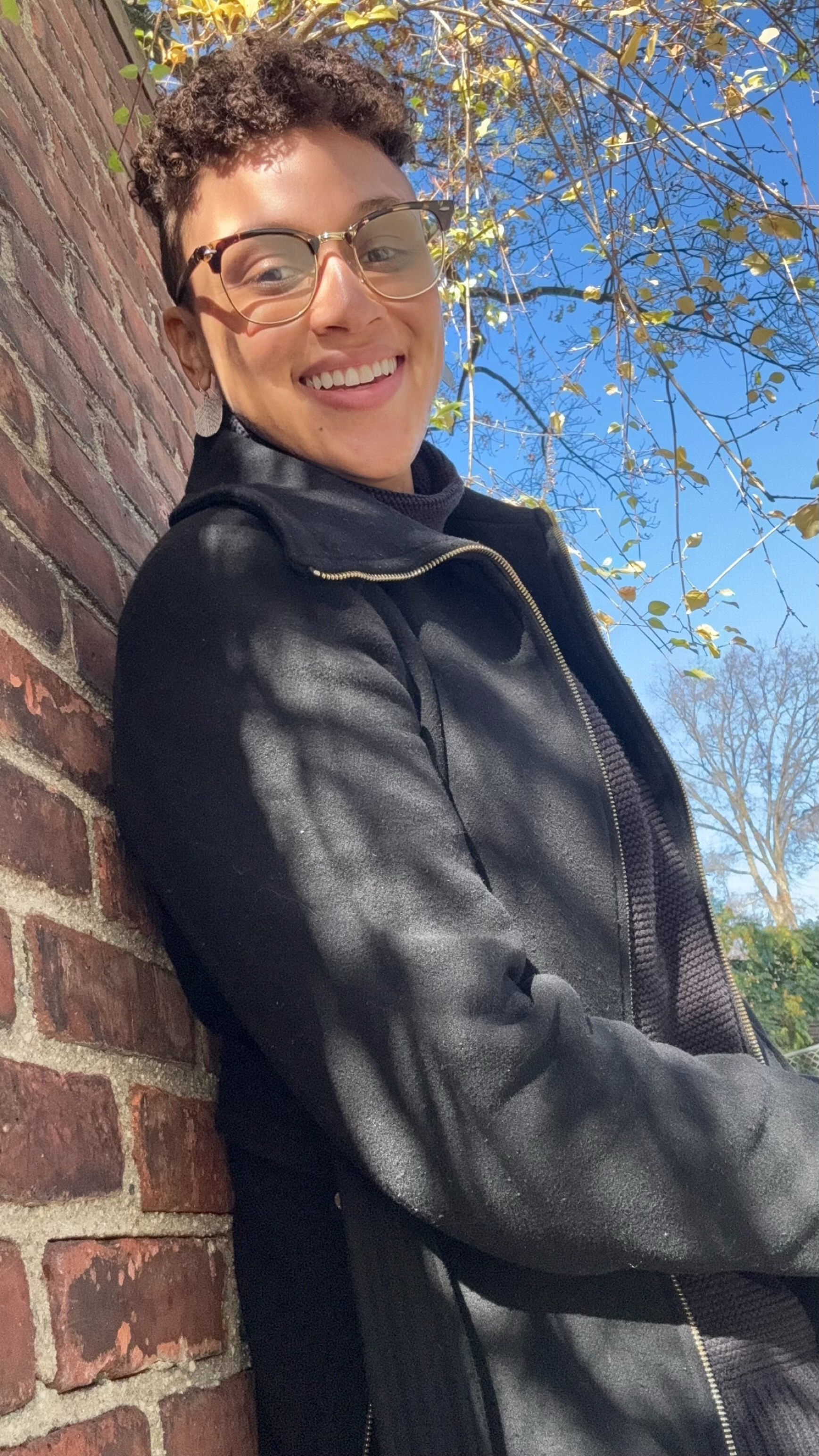 Faithe leaning against a wall